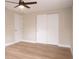 Spacious bedroom with ceiling fan, light wood floors, and a large closet at 7160 Lenape Cir, New Port Richey, FL 34653