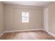 Bedroom features light wood floors, neutral paint, closet and a window at 7160 Lenape Cir, New Port Richey, FL 34653