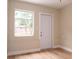 Bedroom features light wood floors, neutral paint, a closet and door to outside at 7160 Lenape Cir, New Port Richey, FL 34653
