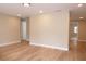 Bright living room with wood-look flooring, recessed lighting, and neutral wall colors at 7160 Lenape Cir, New Port Richey, FL 34653