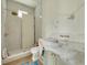 Bright bathroom featuring white subway tile shower, modern fixtures, and marble countertop vanity at 100 37Th Ne Ave, St Petersburg, FL 33704