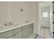Modern bathroom with dual sinks, quartz countertop, and a glimpse into the shower area at 100 37Th Ne Ave, St Petersburg, FL 33704