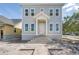 Charming two-story gray home with brick walkway and white trim on a sunny day, new construction at 100 37Th Ne Ave, St Petersburg, FL 33704