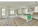 Spacious kitchen with a large island, white cabinetry, and natural light, awaiting your personal touches at 100 37Th Ne Ave, St Petersburg, FL 33704