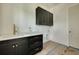 A laundry room with modern black cabinets, white countertops and a stainless steel faucet at 100 37Th Ne Ave, St Petersburg, FL 33704