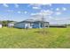 Expansive backyard featuring lush grass and a charming home exterior at 12811 Wanderlust Pl, Parrish, FL 34219