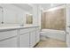Pristine bathroom with double vanity, toilet, and tiled shower/tub combo for relaxation at 12811 Wanderlust Pl, Parrish, FL 34219