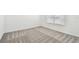 Neutral bedroom featuring patterned carpeting and a bright window with modern blinds at 12811 Wanderlust Pl, Parrish, FL 34219