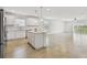 Open-concept living room featuring tile floor, island, and access to the lake at 12811 Wanderlust Pl, Parrish, FL 34219