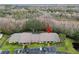 Birds-eye view of condo building with tidy landscaping, parking area, and pond at 13215 Slash Pine Dr # H, Hudson, FL 34669