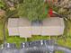 Scenic aerial view of the condo building with lush tree coverage and ample parking at 13215 Slash Pine Dr # H, Hudson, FL 34669