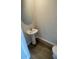 Convenient powder room with pedestal sink and wood-look flooring at 2746 Pearly Banks Dr, Bradenton, FL 34208