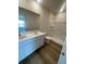 Bathroom featuring double sink vanity, a shower, and vinyl plank flooring at 2754 Pearly Banks Dr, Bradenton, FL 34208
