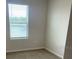 Cozy bedroom showcasing a bright window and carpeted floor at 2754 Pearly Banks Dr, Bradenton, FL 34208