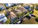Aerial shot of houses along canal with docks and boats, plus pool enclosure, and landscaped yards at 5606 Seagrass Pl, Apollo Beach, FL 33572