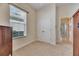 Bedroom featuring a window with blinds, closet with double doors, neutral carpet, and a wooden cabinet at 5606 Seagrass Pl, Apollo Beach, FL 33572