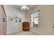 Comfortable bedroom with a ceiling fan, window with blinds, neutral carpet, and a traditional-style armoire at 5606 Seagrass Pl, Apollo Beach, FL 33572