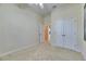 Spacious bedroom with neutral carpet, double-door closet, and access to another room at 5606 Seagrass Pl, Apollo Beach, FL 33572