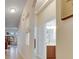 Long hallway featuring an archway, peek-a-boo windows, and access to the bathroom at 5606 Seagrass Pl, Apollo Beach, FL 33572