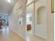 Bright hallway featuring an archway and peek-a-boo windows offering a glimpse of the adjacent bathroom and living areas at 5606 Seagrass Pl, Apollo Beach, FL 33572