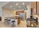 Kitchen island with bar seating, stainless steel refrigerator, gas range, and breakfast area at 5606 Seagrass Pl, Apollo Beach, FL 33572