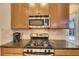 Close up view of the kitchen featuring stainless steel oven, range, microwave, and backsplash at 5606 Seagrass Pl, Apollo Beach, FL 33572