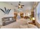 Open-concept living room and kitchen with modern decor, comfortable seating, and stainless steel appliances at 5606 Seagrass Pl, Apollo Beach, FL 33572