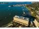 Aerial view of waterfront condominium complex with docks and easy access to bay for boating and other water activities at 100 Bluff View Dr # 205C, Belleair Bluffs, FL 33770