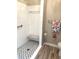 Bathroom features black and white tile in the shower and wood plank flooring in the main room at 100 Bluff View Dr # 205C, Belleair Bluffs, FL 33770