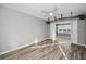 Bright bedroom features wood flooring, neutral walls, large window providing light, and a ceiling fan at 100 Bluff View Dr # 205C, Belleair Bluffs, FL 33770