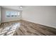 Bright bedroom featuring wood-look floors and natural light from the shuttered window at 100 Bluff View Dr # 205C, Belleair Bluffs, FL 33770