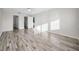 Spacious bedroom with wood-look floors, a ceiling fan, and doors to other rooms at 100 Bluff View Dr # 205C, Belleair Bluffs, FL 33770