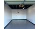 Spacious garage featuring an epoxy floor and ample lighting at 100 Bluff View Dr # 205C, Belleair Bluffs, FL 33770