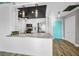 Bright, renovated kitchen features modern stainless appliances, granite countertops, and unique pendant lighting at 100 Bluff View Dr # 205C, Belleair Bluffs, FL 33770