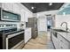 Well-appointed kitchen featuring stainless steel appliances, white cabinets, and plank flooring at 100 Bluff View Dr # 205C, Belleair Bluffs, FL 33770