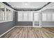 The living room has abundant natural light, charming murals, and wood-look flooring at 100 Bluff View Dr # 205C, Belleair Bluffs, FL 33770