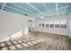 Sunlit living room featuring elegant hardwood floors, a striking coffered ceiling and walls of windows offering serene views at 100 Bluff View Dr # 205C, Belleair Bluffs, FL 33770