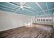 A bright living room featuring a unique blue coffered ceiling, complemented by stylish flooring and ample natural light at 100 Bluff View Dr # 205C, Belleair Bluffs, FL 33770