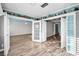 Bright living room features light wood floors, french doors, and whimsical wall decor at 100 Bluff View Dr # 205C, Belleair Bluffs, FL 33770