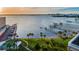 Waterfront views from the building with docks, mature palm trees, and well manicured green spaces at 100 Bluff View Dr # 205C, Belleair Bluffs, FL 33770