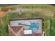 Overhead view of a home with a unique guitar-shaped pool in a screened enclosure at 11910 Climbing Fern Ave, Riverview, FL 33579