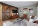 Bonus room virtually staged shows rustic wood accent wall, barn door, and updated furnishings at 11910 Climbing Fern Ave, Riverview, FL 33579