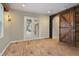 Bonus room features rustic wood accent wall with sliding barn door to additional living spaces at 11910 Climbing Fern Ave, Riverview, FL 33579