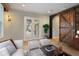 Bonus room virtually staged with sliding barn door and view to lanai at 11910 Climbing Fern Ave, Riverview, FL 33579