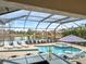 Screened in pool and outdoor kitchen offer a perfect setting to entertain near the pond at 11910 Climbing Fern Ave, Riverview, FL 33579