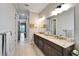 A bright bathroom with double sinks, tile floors and a bright, modern style at 1308 Alhambra Dr, Apollo Beach, FL 33572