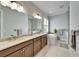 Bright bathroom with double sinks, garden tub, and large window with natural light at 1308 Alhambra Dr, Apollo Beach, FL 33572