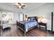 Comfortable bedroom featuring wood floors, ceiling fan, and a decorative furniture set at 1308 Alhambra Dr, Apollo Beach, FL 33572