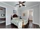 This bedroom features a ceiling fan, a wooden bed frame and a walk-in closet at 1308 Alhambra Dr, Apollo Beach, FL 33572