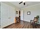 This bedroom features hardwood floors, a ceiling fan and closet doors at 1308 Alhambra Dr, Apollo Beach, FL 33572